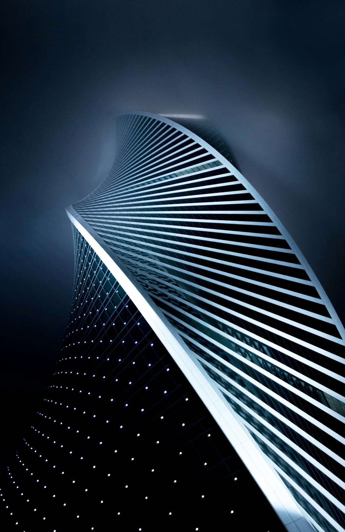 Parametric tower spiralling into night fog